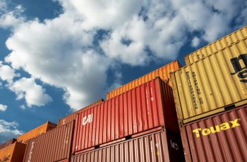 Stacked shipping containers with blue sky in the background